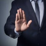 man indicating no with a wave of his hand