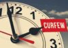 portion of an analog clock with hour hand pointing to 2 pm, with the word CURFEW