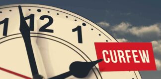 portion of an analog clock with hour hand pointing to 2 pm, with the word CURFEW