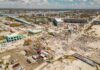 Aerial view of hurricane-damaged buildings and debris.