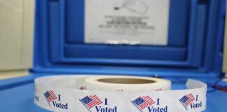 Roll of "I Voted" stickers on table.