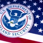 SCOTUS Ruling Gives DHS Unchecked Authority In Immigration Enforcement Department of Homeland Security emblem on American flag.