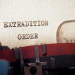 Typewriter typing extradition order on paper