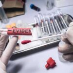 DNA Evidence Shakes Up Alleged Hate Crime Investigation Gloved hands holding evidence tube and cotton swab.