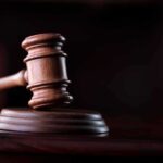 Judge Blocks Trump’s Move, Creates Significant Setback for Administration Wooden gavel on a dark background.