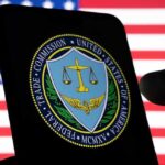 New FTC Report Reveals Staggering $12.5B Fraud Losses in 2024 FTC logo on smartphone with American flag background.