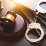 Unbelievable: Wi-Fi Dispute Leads to Attempted Murder Charges Gavel, books, and handcuffs on a table.