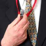 IRS Whistleblowers Who Exposed Hunter Biden Bias Promoted Person holding a whistle on a red lanyard.