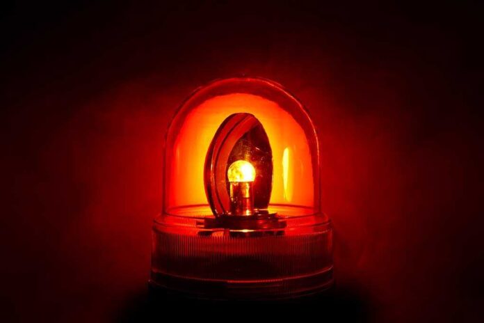 71029123 featured image Red emergency light glowing in the dark.