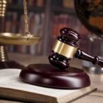 Conservatives Rejoice as Radical Law Shot Down in 6-1 Ruling Gavel on book beside scales of justice