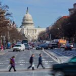 People crossing street near the U.S. Capitol building.