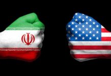 Two fists painted with Iran and USA flags