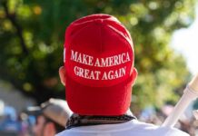 Red Make America Great Again hat on person's head