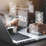 How Do Tariffs and Trump’s Policies Fuel Economic Growth? Person typing on laptop with tax-related icons displayed.