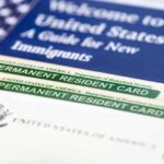 Permanent resident cards with welcome guide and flag.