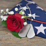 Final Remains Recovered From US Military Training Tragedy Dog tags red rose and folded American flag