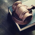 Mother Found Not Guilty in Double Homicide By Reason of Insanity Wooden gavel resting on thick book