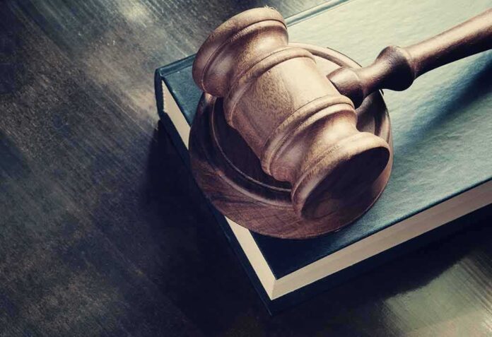 299616500 featured image Wooden gavel resting on thick book