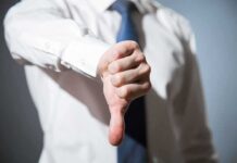Person giving a thumbs down gesture.