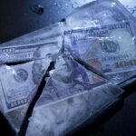 USDA Freezes Funding After Multiple Warnings Ignored Hundred dollar bills frozen in cracked ice block