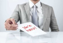 Person handing a paper with Youre Fired text.
