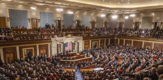 Audience in a large hall with central podium