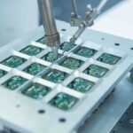 Robotic arm assembling electronic circuit boards in production