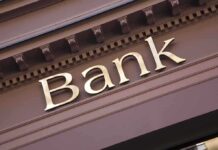 Gold bank sign on building facade