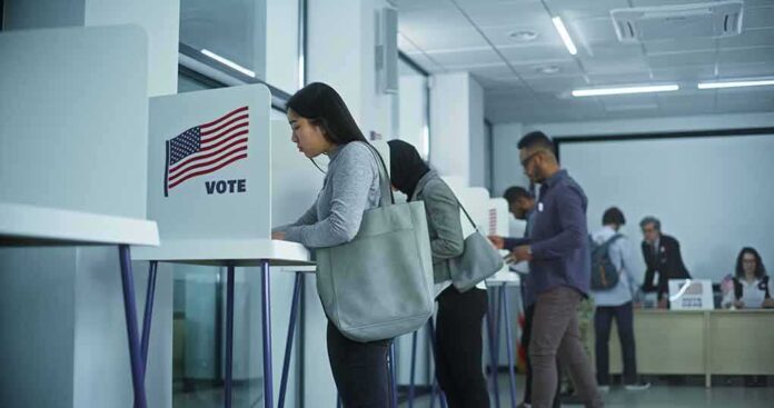 2451104741 featured image People voting in booths at a polling station.
