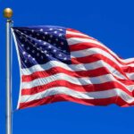 United States flag waving against blue sky