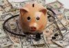 Piggy bank with stethoscope on dollar bills