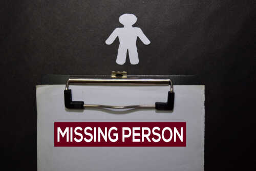 Clipboard with missing person sign and silhouette figure