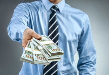 Person handing over a stack of money for investment