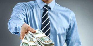 Person handing over a stack of money for investment