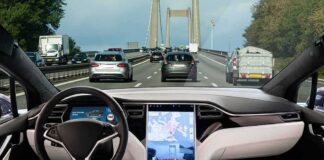 Car interior with self-driving mode on highway.