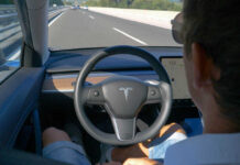 Person using autopilot in Tesla on highway