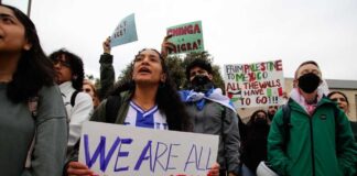 People at protest holding signs about immigration rights