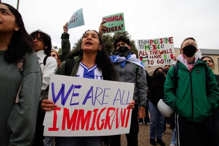 177507209 featured image People at protest holding signs about immigration rights