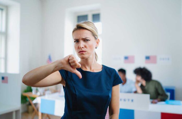 Woman with thumbs down in voting location