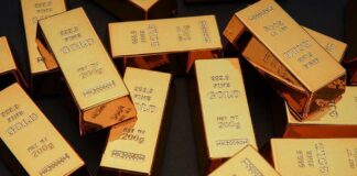 Gold bars stacked on dark background