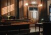 Empty courtroom with wooden interior and green lamps