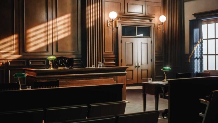 2056420760 featured image Empty courtroom with wooden interior and green lamps