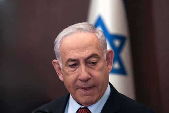 2415917203 featured image Man in suit with Israeli flag in background