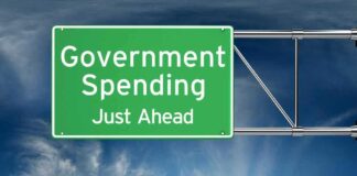 Green road sign: "Government Spending Just Ahead."