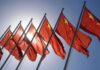 Red flags with yellow stars on flagpoles