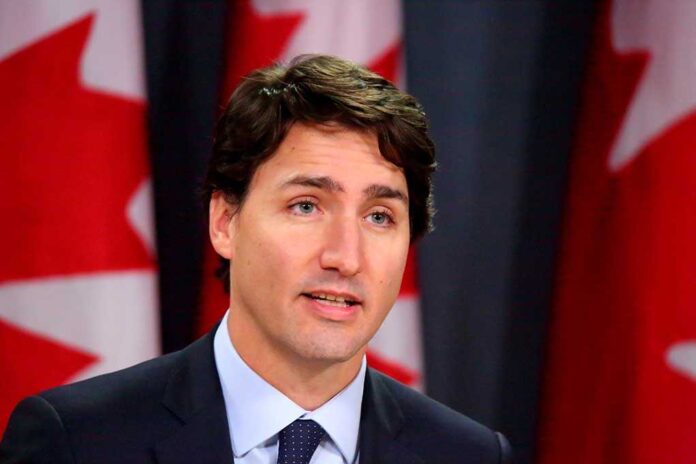 373957918 featured image Man speaking in front of Canadian flags