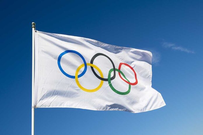 430080421 featured image Olympic flag waving against clear blue sky
