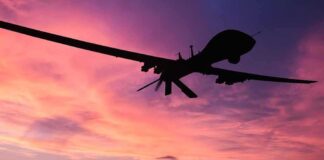 Silhouette of a drone against a colorful sunset