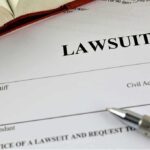 Lawsuit document with pen and open book