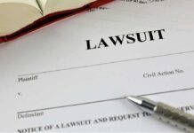 Lawsuit document with pen and open book